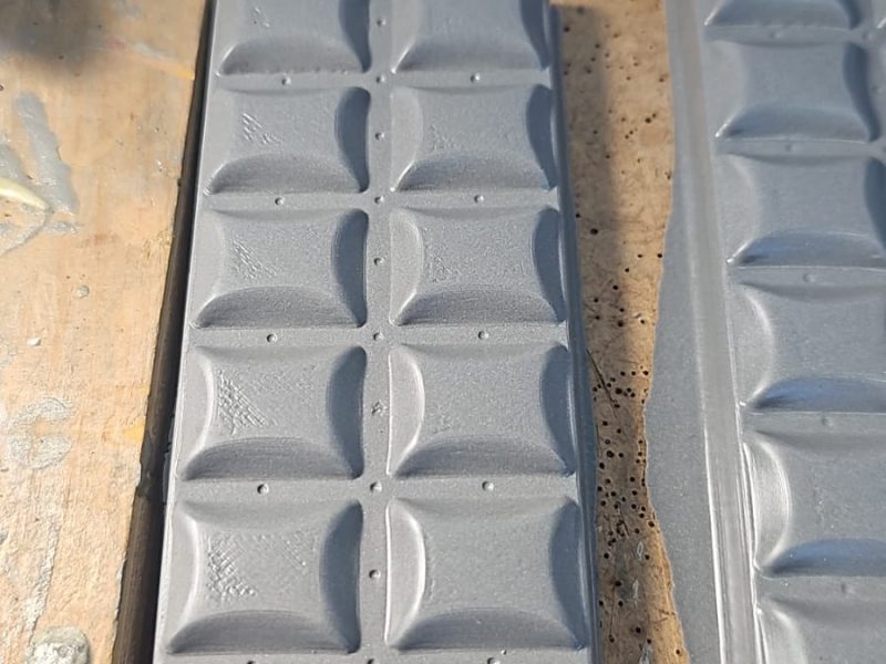 Grey 3D-printed chocolate-bar mould prototype on a workshop bench.