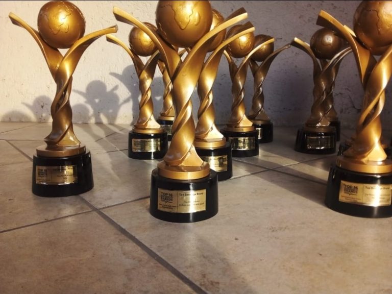 Set of gold Africa-globe trophies arranged for a business awards event.