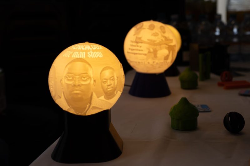 Pair of illuminated 3D-printed lithophane dome lamps displaying personalised portraits.